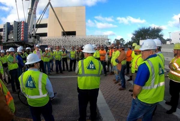 澳门足彩app team members participating in a safety meeting on a job site.